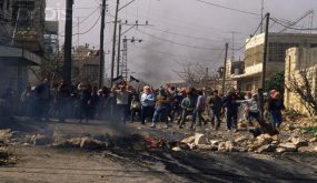 24 Feb 1988, Beit Ummar, West Bank --- Palestinian demonstrators throw stones at Israeli soldiers during a protest in the streets of Beit Omar. Violence broke out after rebel Israeli and Palestinian fighters protested in the disputed territory of West Bank during the first Intifada. | Location: Beit Omar, West Bank. --- Image by © Patrick Robert/Sygma/CORBIS