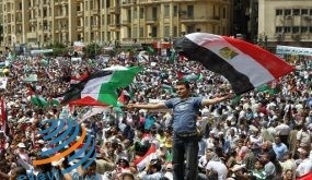 An Egyptian demonstrator waves Egyptian (R) and Palestinian flags as thousands gather at Cairo's Tahrir Square on May 13, 2011 during a protest calling for national unity after attacks on Egyptian churches, and solidarity with the Palestinians as they mark the "Nakba" or "catastrophe" which befell them following Israel's establishment in 1948. AFP PHOTO / KHALED DESOUKI (Photo credit should read KHALED DESOUKI/AFP/Getty Images) (Newscom TagID: afplivethree889040) [Photo via Newscom]