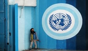 A Palestinians boy sits near the headquarters United Nations Relief and Works Agency (UNRWA) in Gaza city on January 6, 2018. US envoy to the UN Haley warned US support for UNRWA would end if the PA refuses to enter negotiations with Israel. Despite Mr. Trumps Twitter message, Chris Gunness, an Unrwa spokesman, said the agency had not received any formal notification that the Trump administration intended to cut its funding. The United States is the top funder of Unrwa, and according to figures released in 2016, it contributed nearly $369 million. Photo by Ashraf Amra