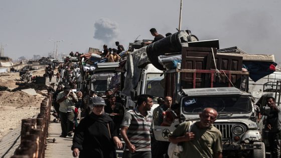 GAZA CITY, GAZA - SEPTEMBER 13: Smoke rises as Palestinians leave their homes with their belongings along Rashid Street due to intense Israeli military attacks and forced evacuation warnings in the northern Gaza Strip, on September 13, 2025. ( Moiz Salhi - Anadolu Agency )